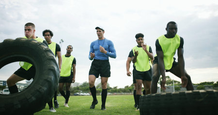 Fitness, coach and men with tire on field, strength challenge and instructions for sports training. Coaching, instructor or rugby team with exercise for muscle development, active or weightlifting