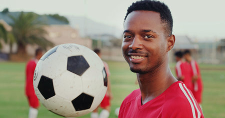 Portrait, soccer and happy man with ball at pitch for sports, match training or team competition. Smile, football player and person with equipment outdoor, professional athlete or practice at game