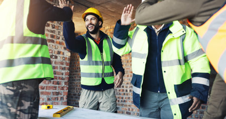Engineer, team and high five at construction site with blueprint, celebration and talk for building design. Architect, men and floor plan with partnership, success and infrastructure layout approval