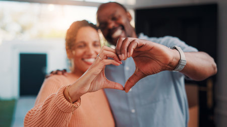 Heart hands, happy and couple in home with support, bonding and connection in marriage on date. Smile, emoji and African man with woman for love gesture with commitment, trust or relationship.