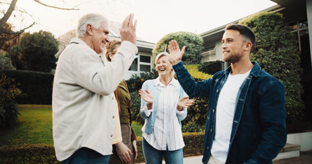 Happy, celebration and family outdoor by house for applause excited and parents with adult siblings. High five, clapping and success with good news in driveway, senior people with son and daughter