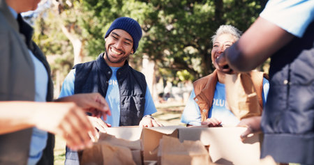 Volunteer, team and donation package in park with smile, outreach contribution and non profit group. Happy people, charity project and paper bags outdoor with social responsibility, support and help.