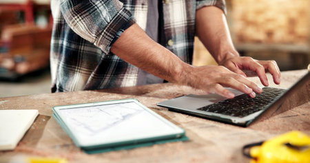 Planning, hands and typing on laptop for carpentry, cut list update and log client revision on app. Carpenter, person and tech screen in workshop for material specs, supplier website and lumber order