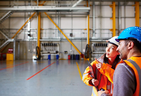 Engineer, team and talk at warehouse with clipboard, inspection and compliance for maintenance. People, point and collaboration at factory with checklist report, quality control and safety evaluation