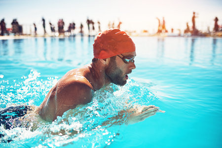 Training, man and swimming in pool for workout, exercise and aquatic practice for body wellness. Male person, swimmer and fitness for water sports, stroke style or health lifestyle in summer outdoor