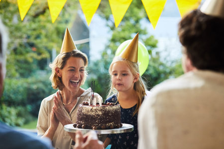Singing, child and blow cake for birthday party, family gathering and celebration for growth. Girl, happy mother and cheering in home garden for special event, milestone and dessert candles for wish