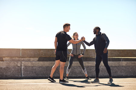 Handshake, fitness and team with personal trainer in city for workout, discussion and client training. Exercise, shaking hands and smile with people outdoor for summer performance, cardio and runner