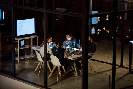 Night, meeting and team with fast food in business, colleagues and conversation for brand awareness. Marketing, collaboration and happy people with tech, above and working late with meal in office