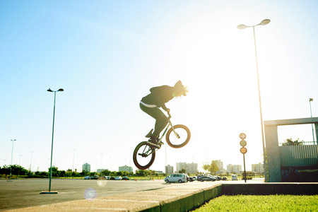 Bicycle, air and man with trick in city with flare, jump or stunt for extreme sports outdoor. Skill, action and person on bike for fitness, cyclist challenge or rider with talent in urban park