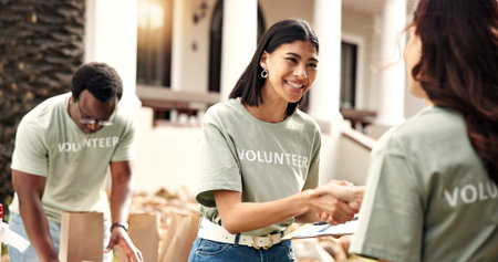 Clipboard, volunteer or happy woman with handshake for donation, checklist or charity campaign. Female person, activist and shaking hands with smile for community service or outdoor outreach together