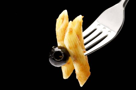 Penne pasta with bolognese sauce on a black backgroundの写真素材