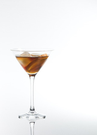 red vermouth with ice cubes and orange slice, clean reflection on a white backgroundの写真素材