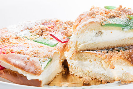 This cake full of cream with glazed fruit is a typical cake is the 6 of january when the wise men visit the childrens to give their presents, it is called as roscon de reyes, inside of the cream has surprises like small figures and the black bean, if you の写真素材