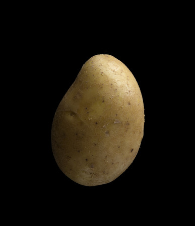 potato isolated on a black backgroundの写真素材