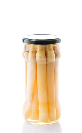 white asparagus jar on a white background with a black lidの写真素材