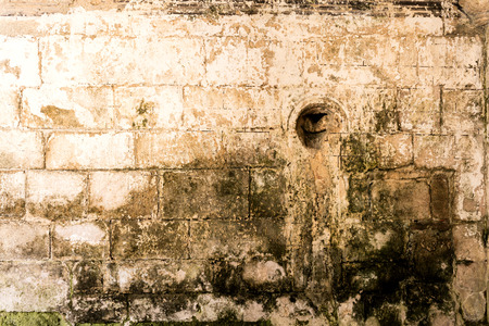 old stone wall made with granite piecesの写真素材