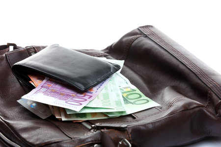 wallet with money on a leather bag