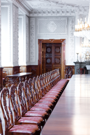 large dining room with luxurious wooden chairs and parquet floorのeditorial素材