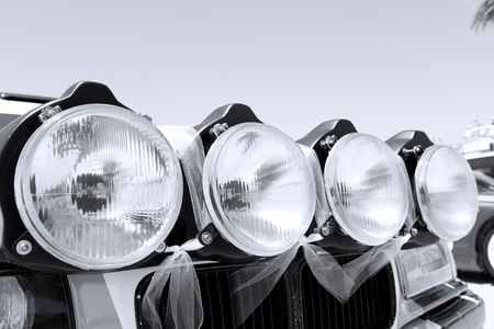 4 big race front lights in a vintage car, black and white photography with free space for text on topの写真素材