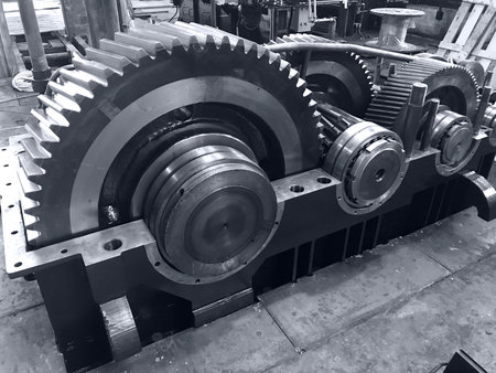 large gearbox open, showing the gears, the whole set attached to a shaft with a cap, industrial...