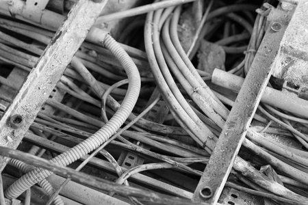 electric cable duct open, showing different thickness, with a dirty appearance in an industrial environment, waiting to be removed. Black and white photoの写真素材