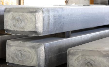 heavy aluminum slabs stacked in a warehouse foundry, raw material to be processed in a hot millの写真素材
