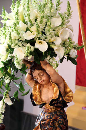 Figure of an angel with bouquet of flowersの写真素材