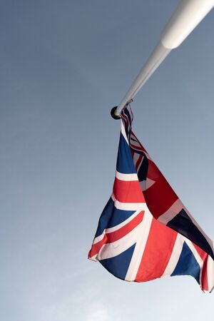 United Kingdom flag on the white pole.の写真素材