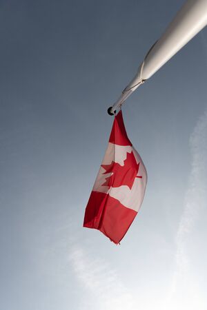 Canadian flag on a white pole.の写真素材