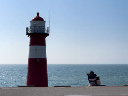 Lighthouse on the coast with a view of water.の写真素材