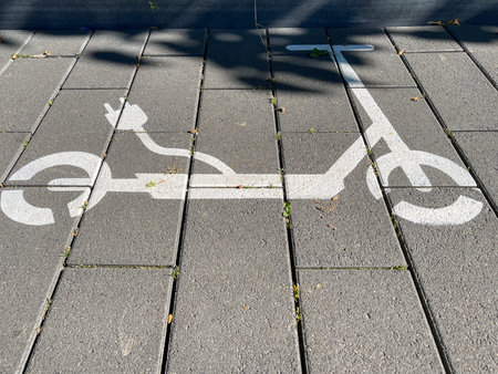 A view of a street. Electric scooter charging station, symbol on the street.
