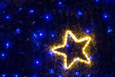 Christmas decoration a shining star on the blue background.の写真素材