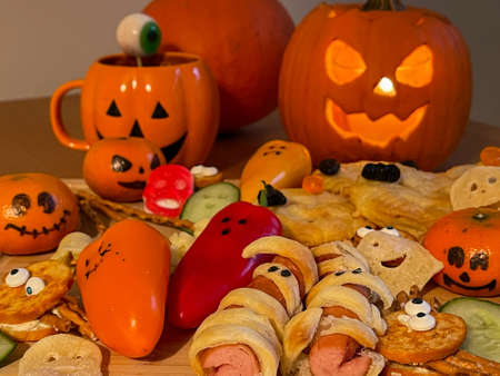 Halloween and autumn food and table decorations. Biscuits, pumpkins, savouries, sweet and savoury for everyone.の写真素材