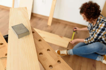 A woman worker in the carpenter workroom renovation. High quality photoの写真素材