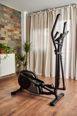 Elliptical cross training machine in the living room of the house
