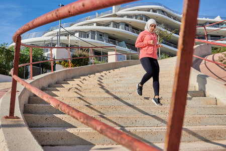 Muslim young woman wears a hijab while running