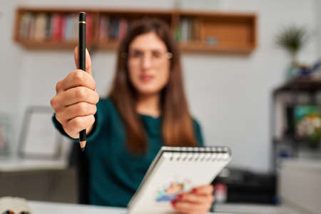 illustrator measuring with her hand and pencilの写真素材