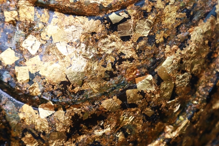 The gold leaf on the back of Buddha statue in temple of Thailand, selective focus gild texture background.の写真素材