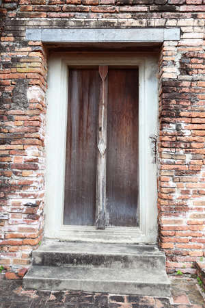 Wooden door frame in a antique sanctuary. Wat Putthaisawan, Ayutthaya Thailand. Brick wall.の写真素材