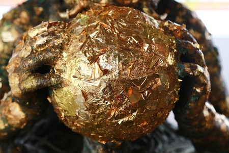 The gold leaf on the back of Buddha statue in temple of Thailand, selective focus gild texture backgroundの写真素材