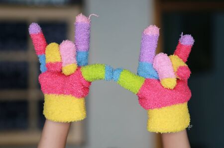 Knitted children's glove with colorful stripesの写真素材