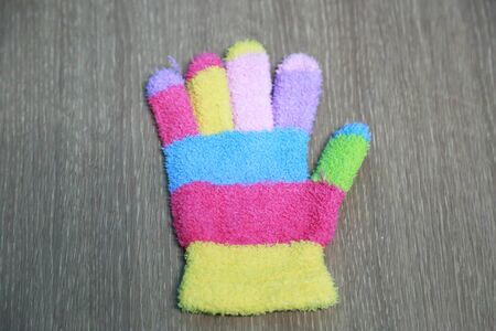 Knitted children's glove with colorful stripesの写真素材