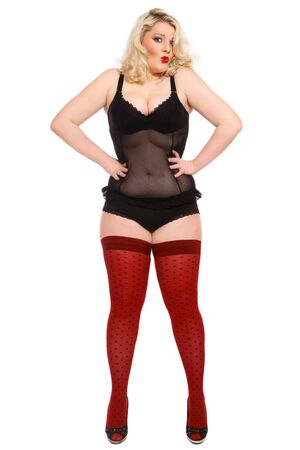 Humorous shot of beautiful blond plus-size woman in sexy lingerie and stockings Humorous shot of beautiful blond plus-size woman in sexy lingerie and stockings