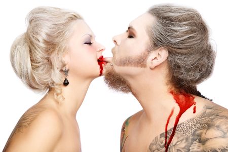 Portrait of pierced tattooed man and woman with old-fashioned make-up and hairstyle playing vampiresの写真素材
