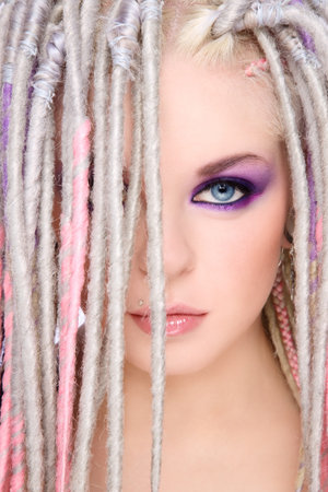 Close-up portrait of young beautiful girl with stylish make-up and dreads