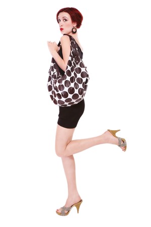 Humorous shot of young slim stylish woman in vintage combi and polka dot hand bagの写真素材