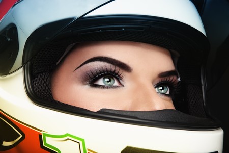 Close-up portrait of beautiful woman with stylish makeup in biker helmetの写真素材