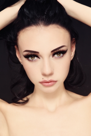 Portrait of young beautiful woman with stylish make-up touching her hairの写真素材