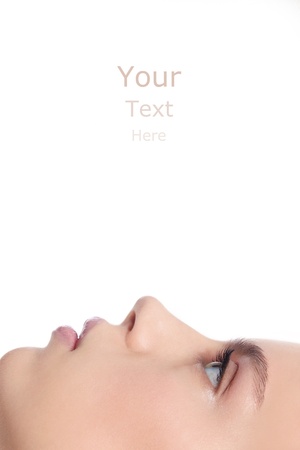 Profile of young beautiful healthy girl with copy space above over white backgroundの写真素材