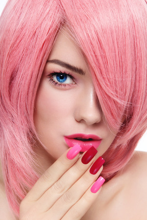 Close-up portrait of young beautiful girl with pink hair and fancy manicureの写真素材